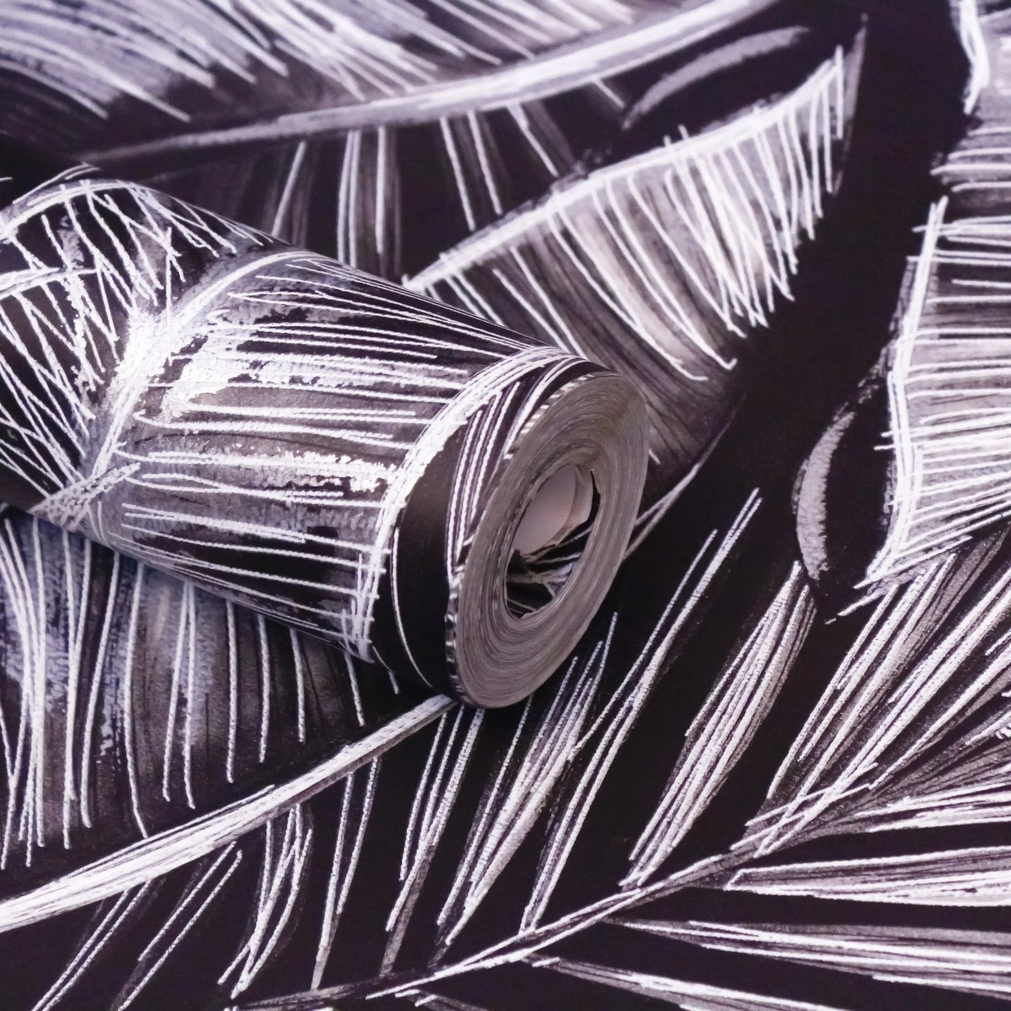 Roll of silver metallic tape on a black background with white lines.