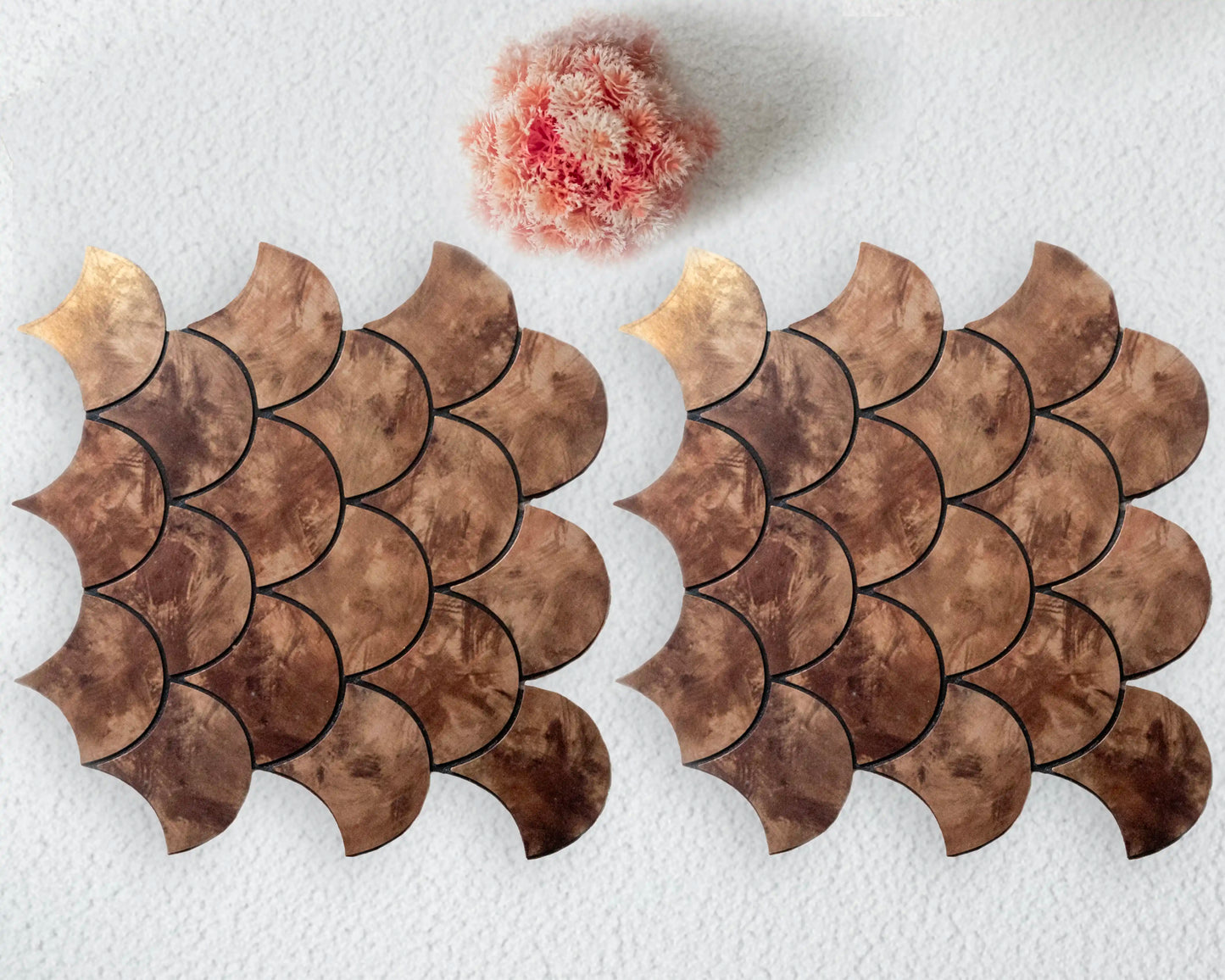 Two decorative stone tiles with scalloped edges on a white background