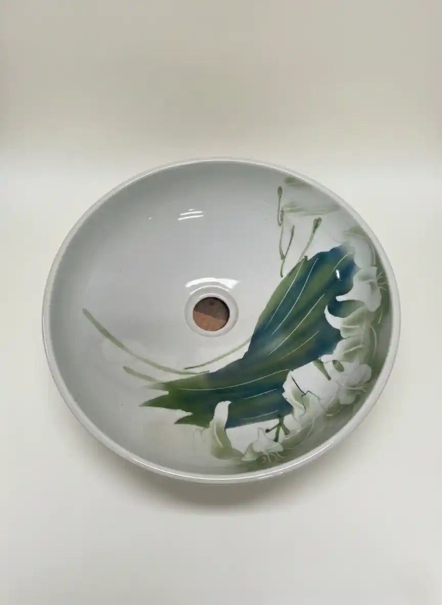 Ceramic sink with floral design on a white background