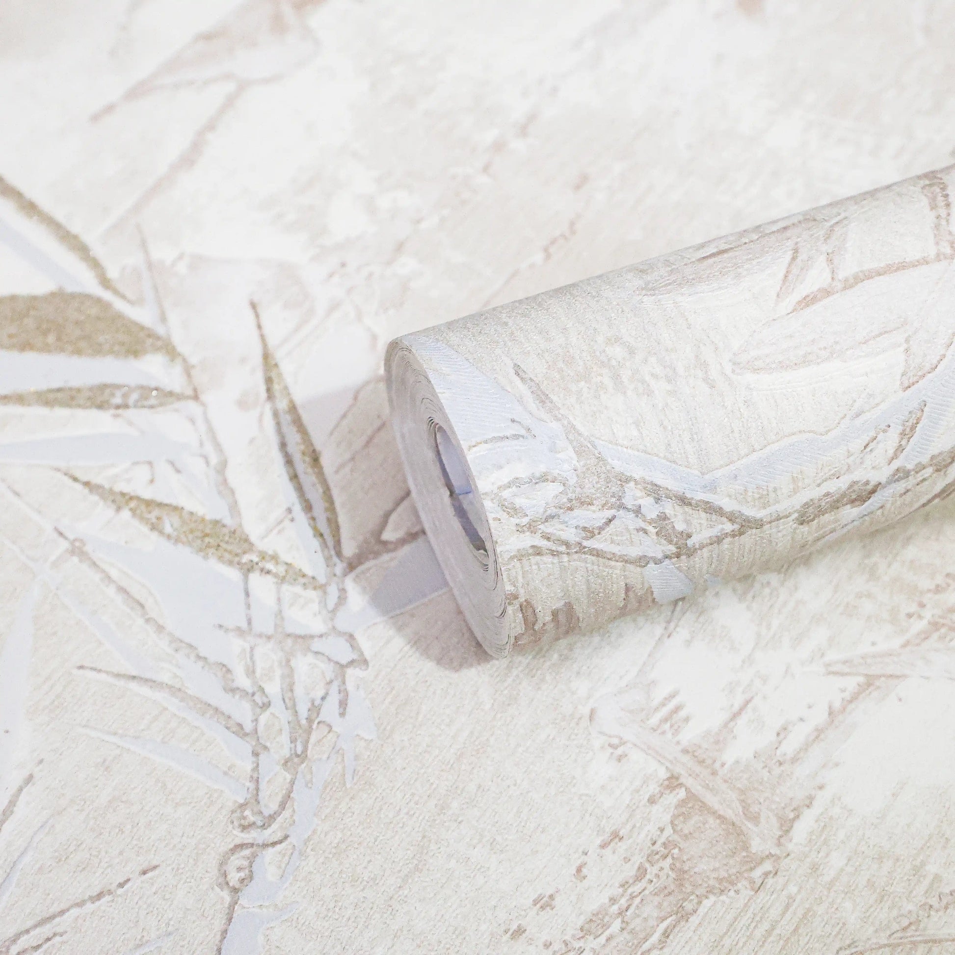 Roll of wallpaper with a subtle leaf pattern on a matching background