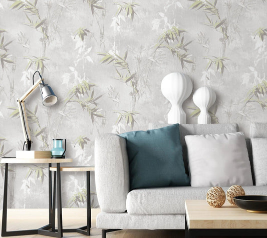 Living room with a gray sofa, decorative pillows, and a lamp against a floral wallpaper.