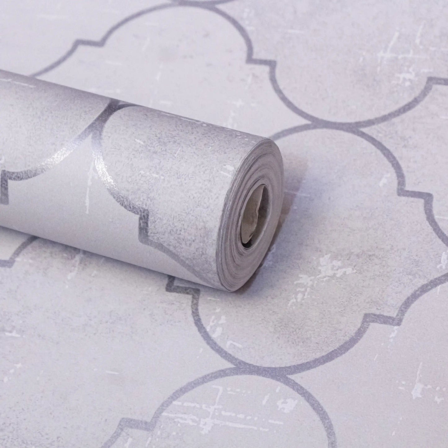 Roll of wallpaper with a geometric pattern on a matching background