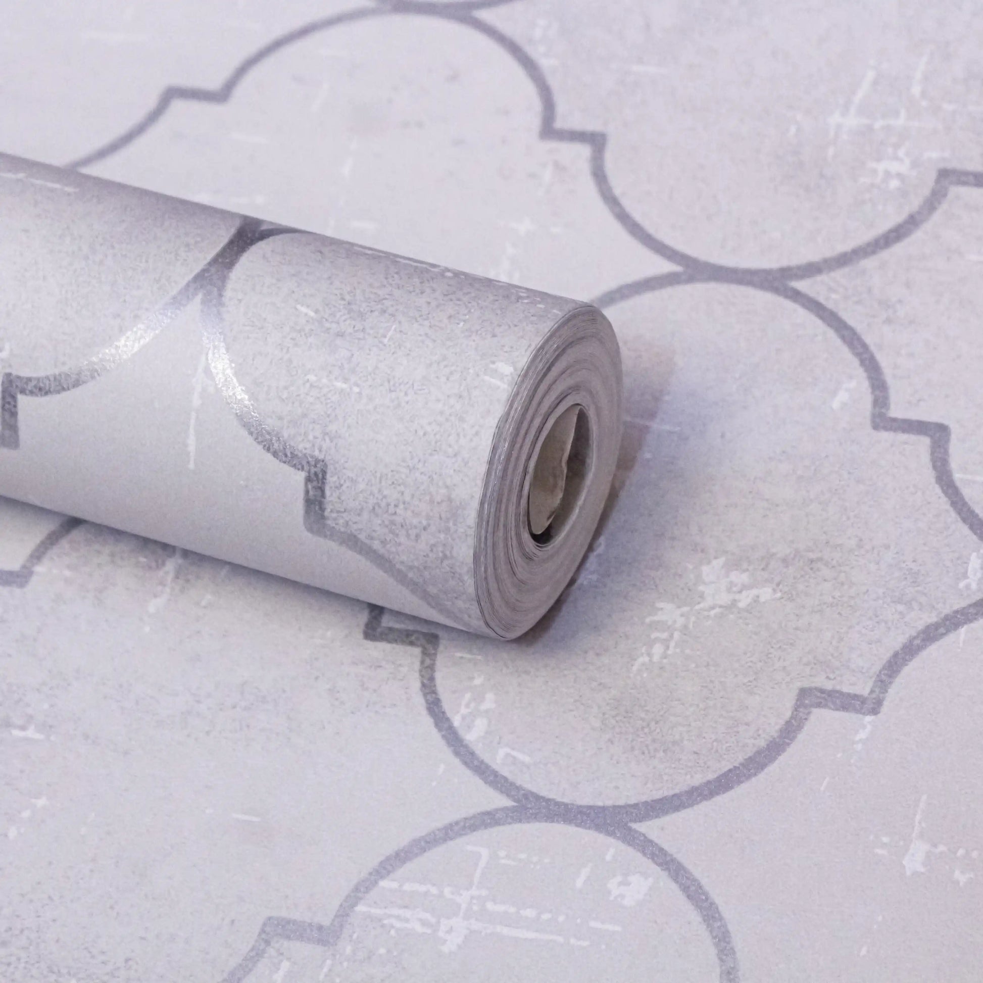 Roll of wallpaper with a geometric pattern on a matching background