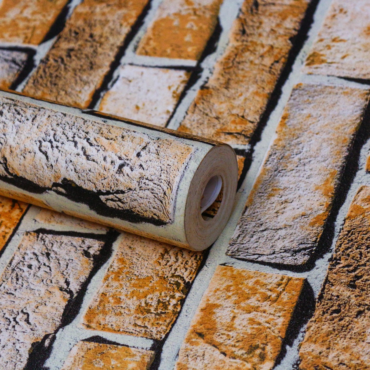 Roll of brick-patterned wallpaper on a matching patterned surface