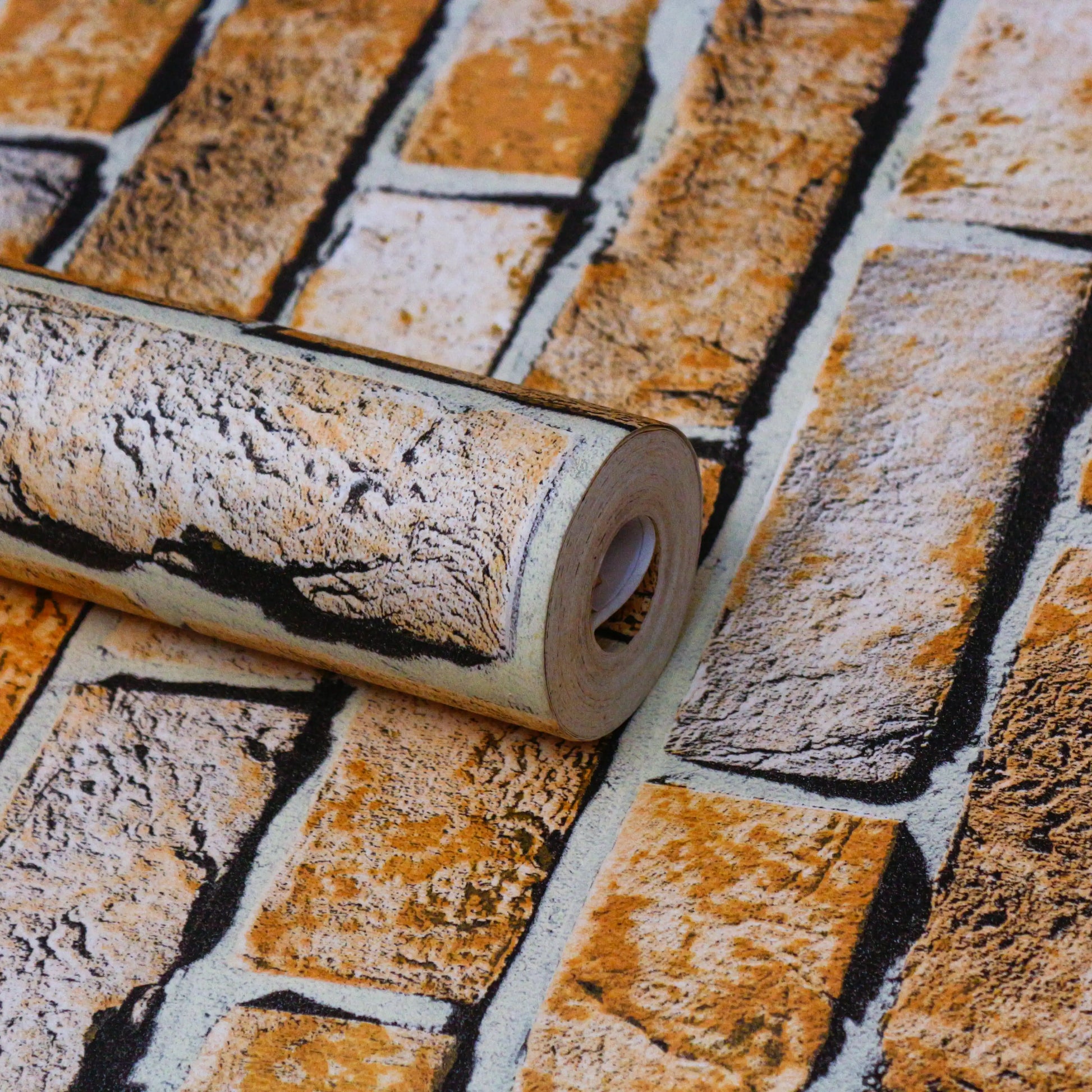 Roll of brick-patterned wallpaper on a matching patterned surface