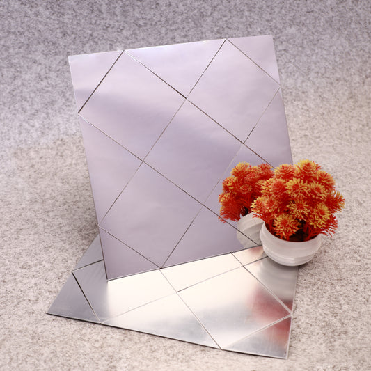 Reflective mirror tiles on a textured surface with a potted plant.