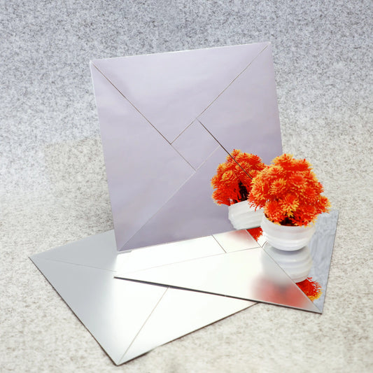 White envelope with orange flowers on a textured surface