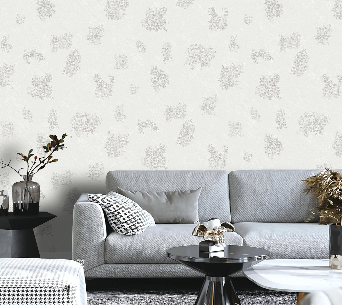 Living room with a gray sofa, decorative pillows, and a patterned wall.