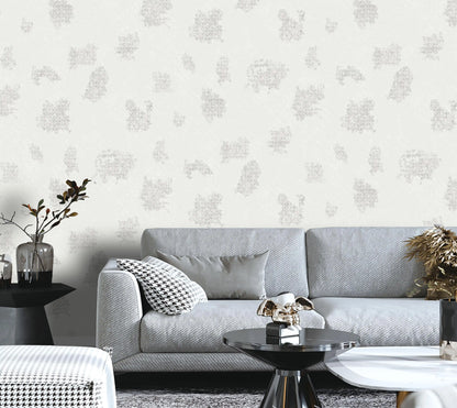 Living room with a gray sofa, decorative pillows, and a patterned wall.
