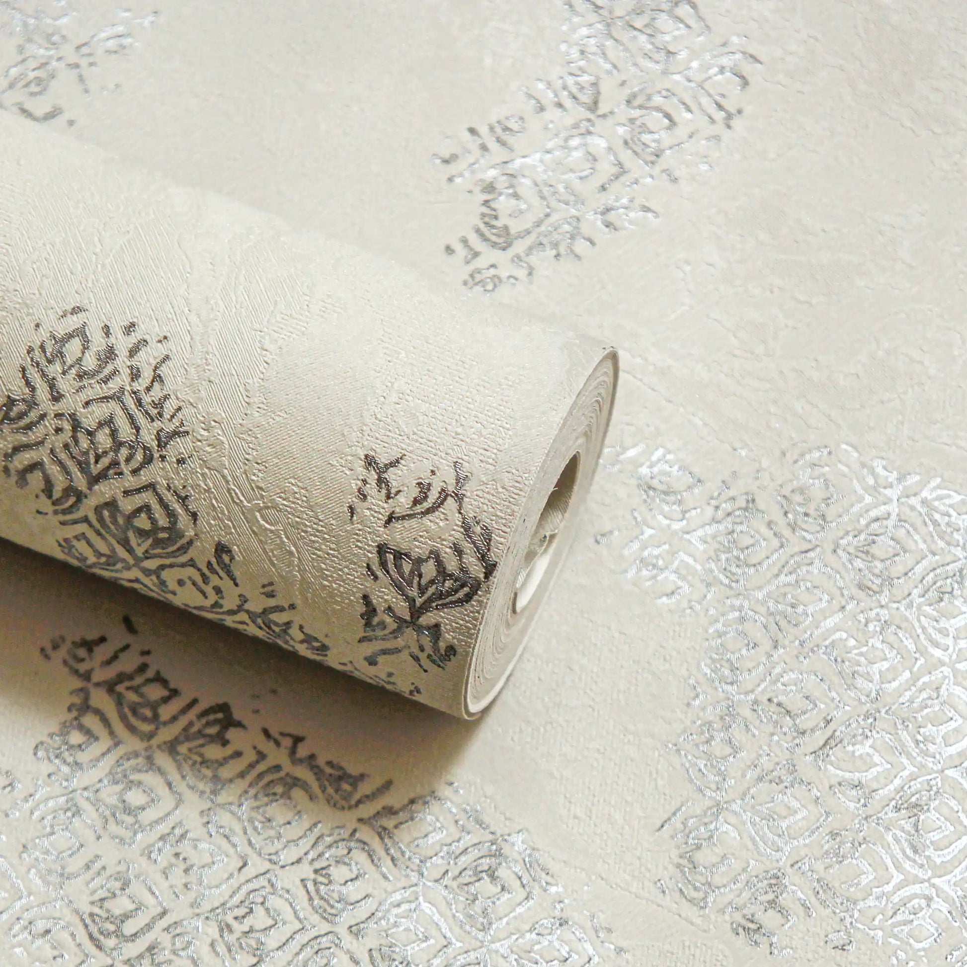 Roll of textured wallpaper with intricate patterns on a matching background