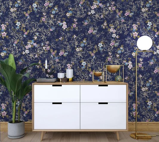 White dresser with decorative items against a floral wallpapered wall