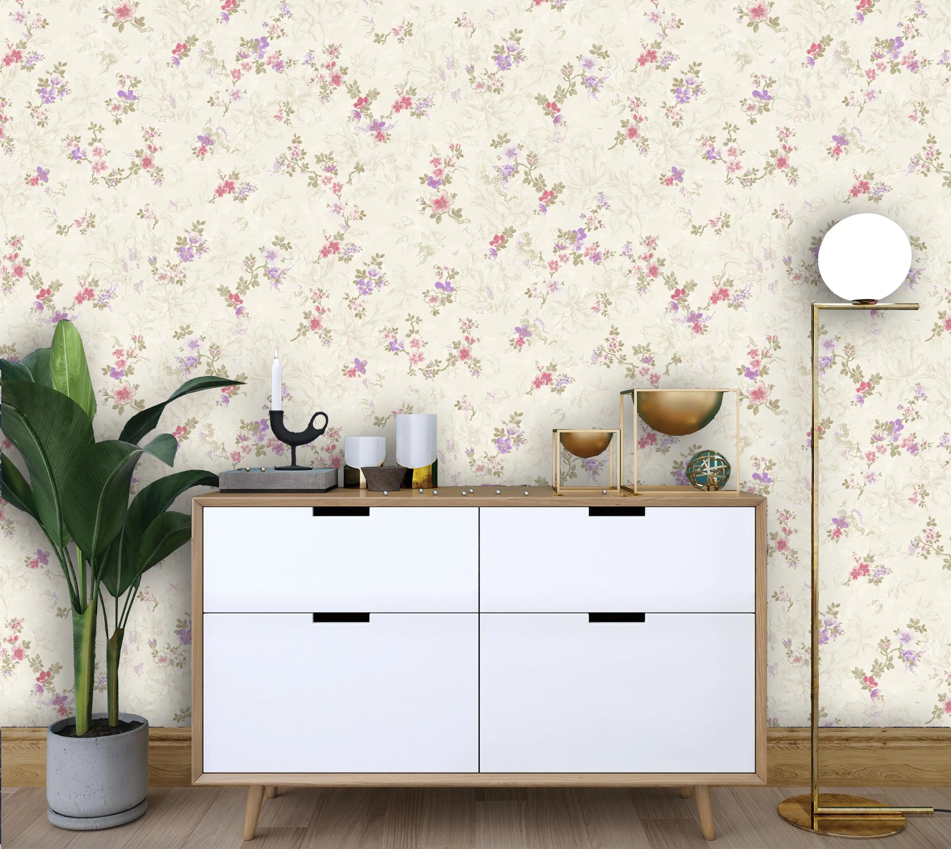 White dresser with decorative items against a floral wallpapered wall