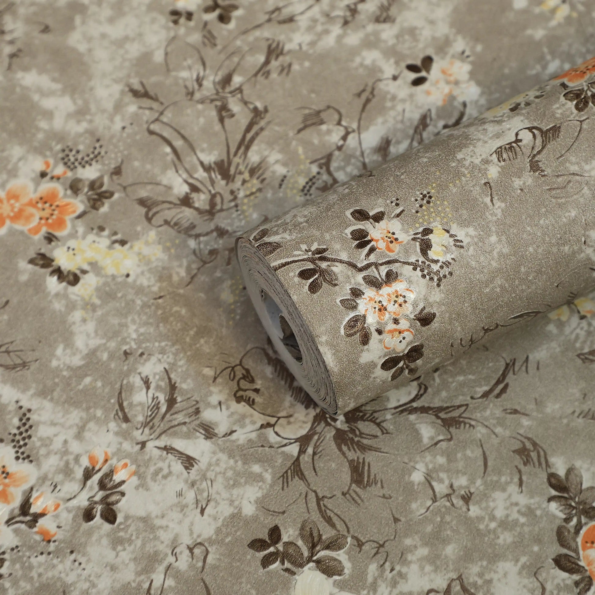 Roll of floral-patterned fabric with a beige background
