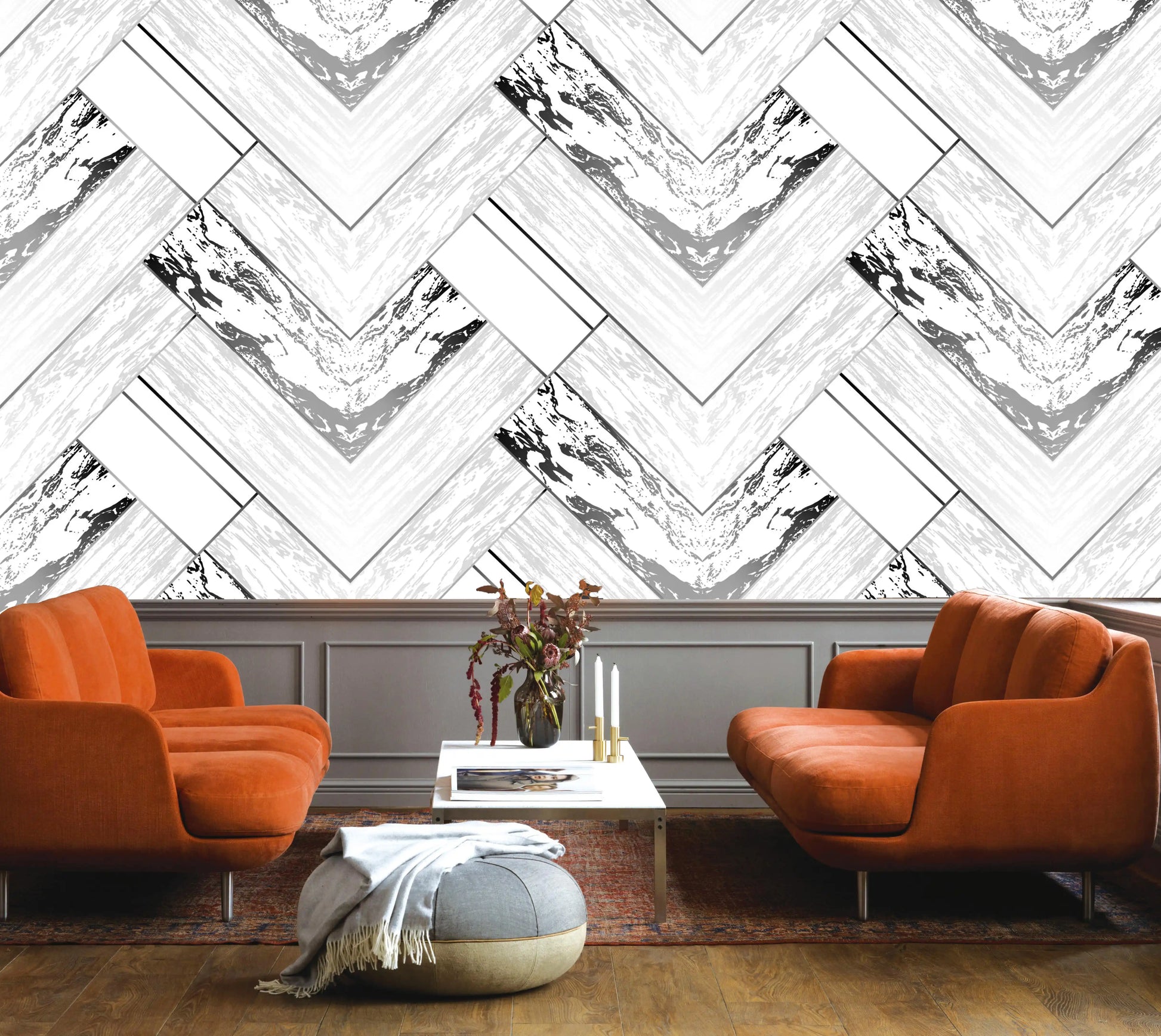 Modern living room with orange chairs and a chevron-patterned wall.
