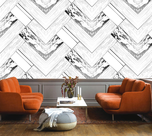 Modern living room with orange chairs and a chevron-patterned wall.