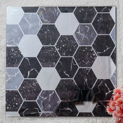 Hexagonal tiles with a black and gray marble pattern on a textured surface.