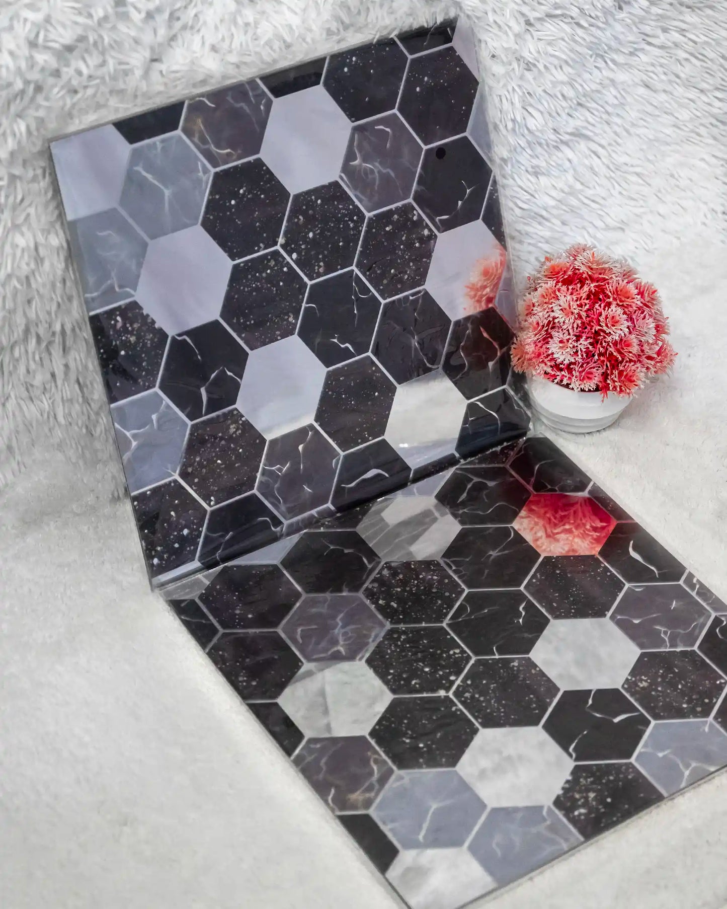 Hexagonal patterned box on a textured surface with coral decorations.