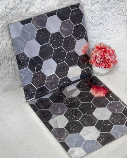 Hexagonal patterned box on a textured surface with coral decorations.