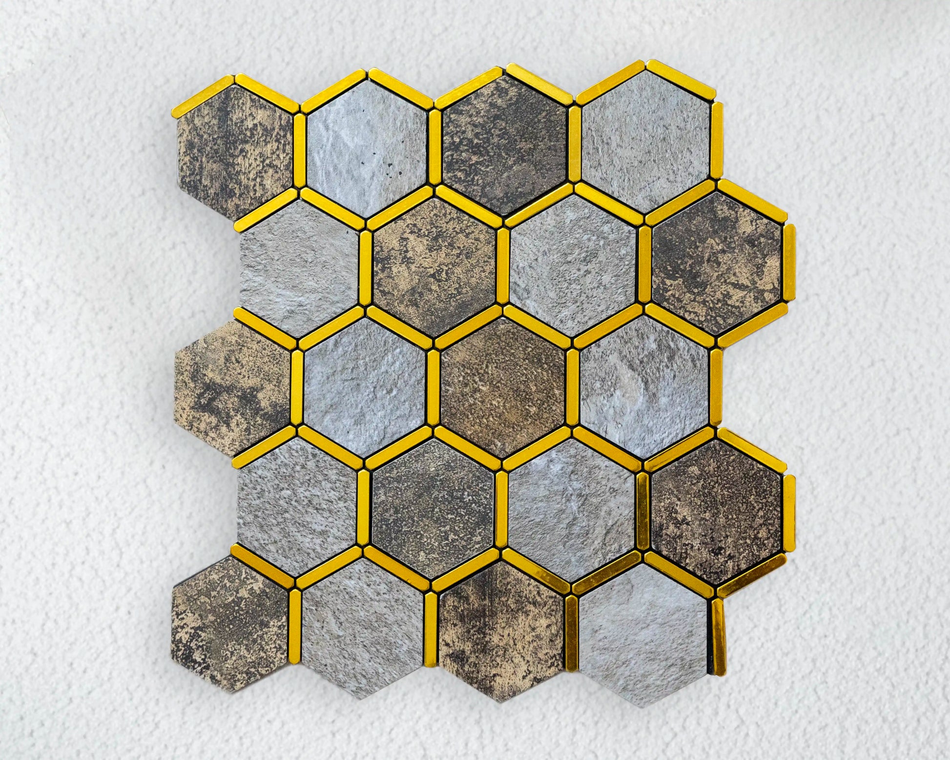 Hexagonal tiles with gold borders on a textured white background