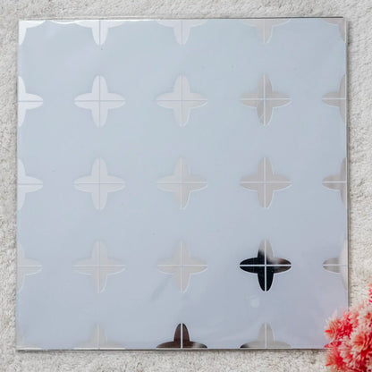 Decorative wall sticker with geometric pattern on a textured wall.