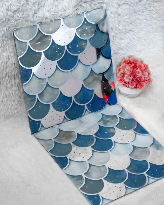 Two decorative mats with fish scale pattern on a white surface