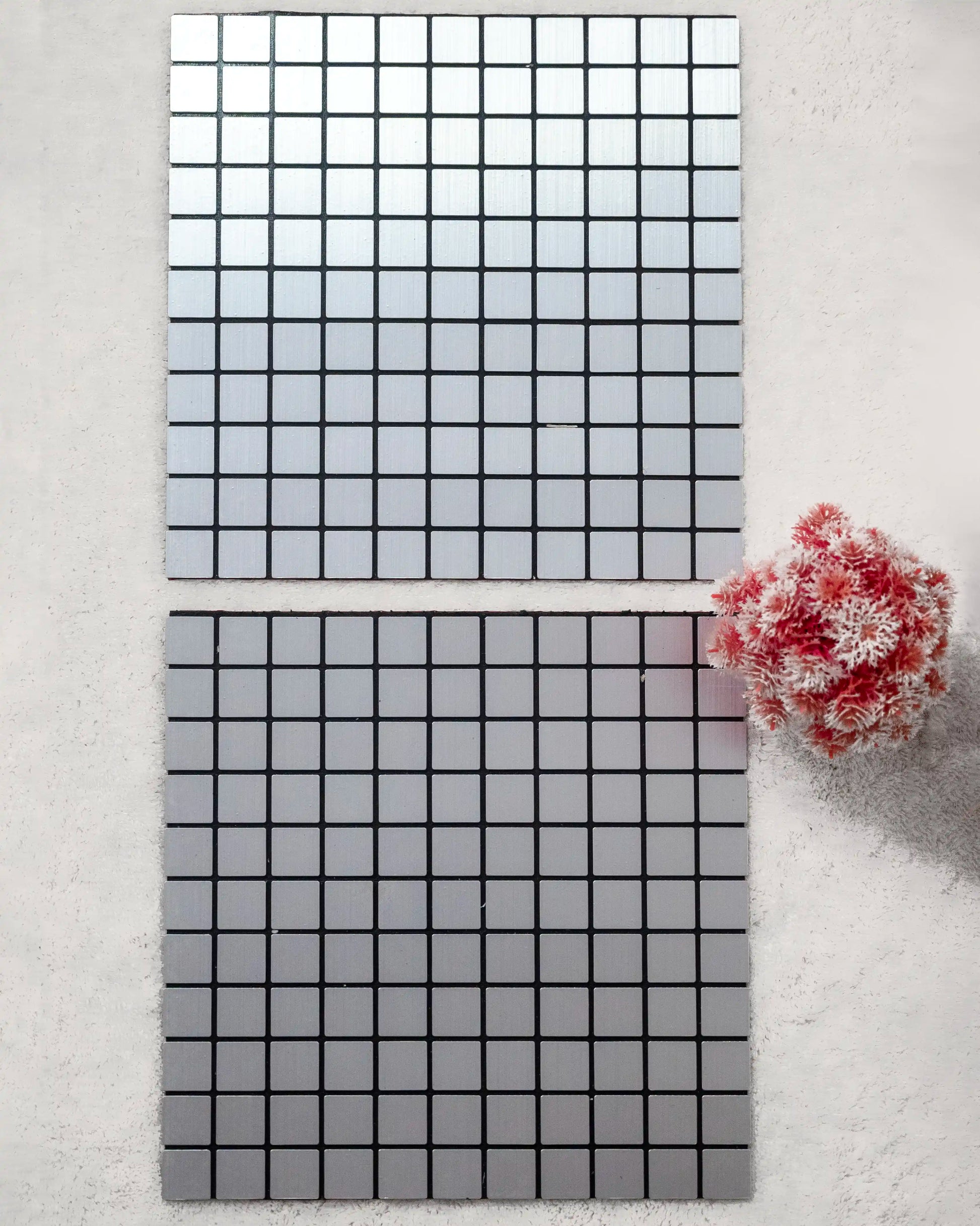 Two rectangular tiles with grid patterns on a light gray background