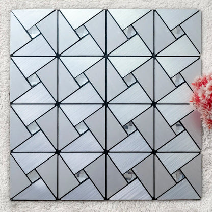 Geometric patterned tile on a textured surface with a floral arrangement.