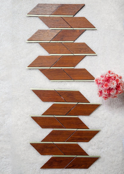 Wooden tiles arranged in a geometric pattern on a textured surface with a pink flower.