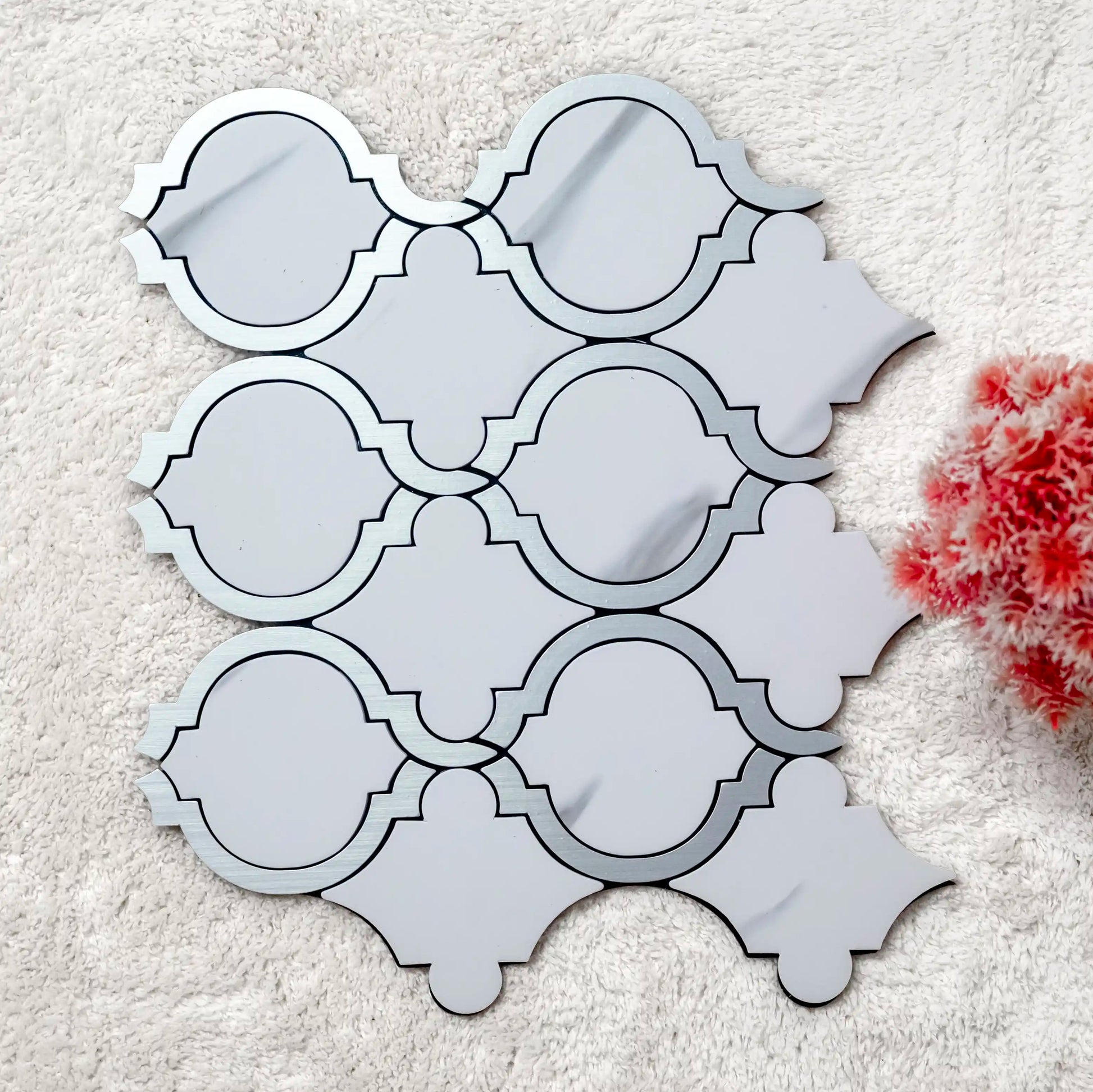 Decorative mirror with geometric pattern on a textured surface