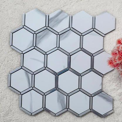 Hexagonal mirror tiles with metallic border on a textured surface