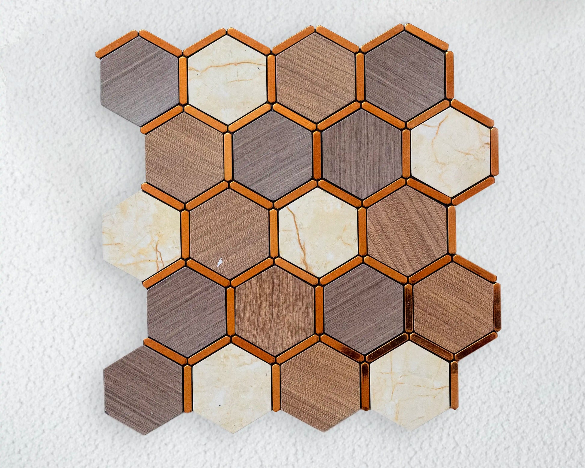 Hexagonal mosaic tile sample with wood and stone patterns on a textured white background