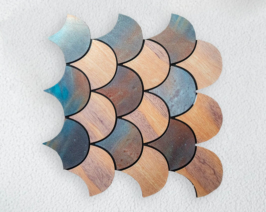 Decorative wall tile with scalloped edges in brown and blue on a textured white background
