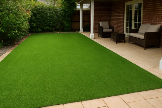 Artificial grass installed on a patio area in front of a house.