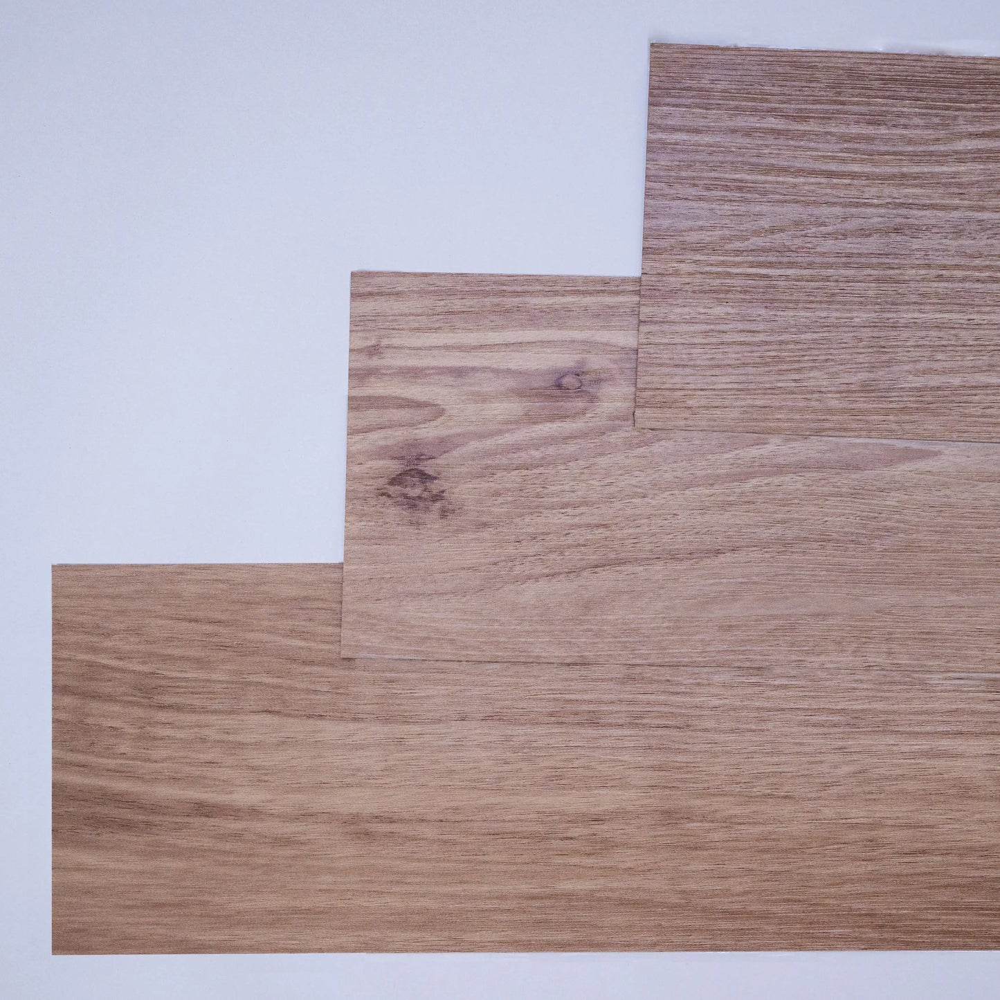 Three pieces of wood with a wooden texture on a light gray background