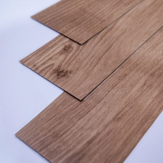 Close-up of wooden flooring panels on a light gray background