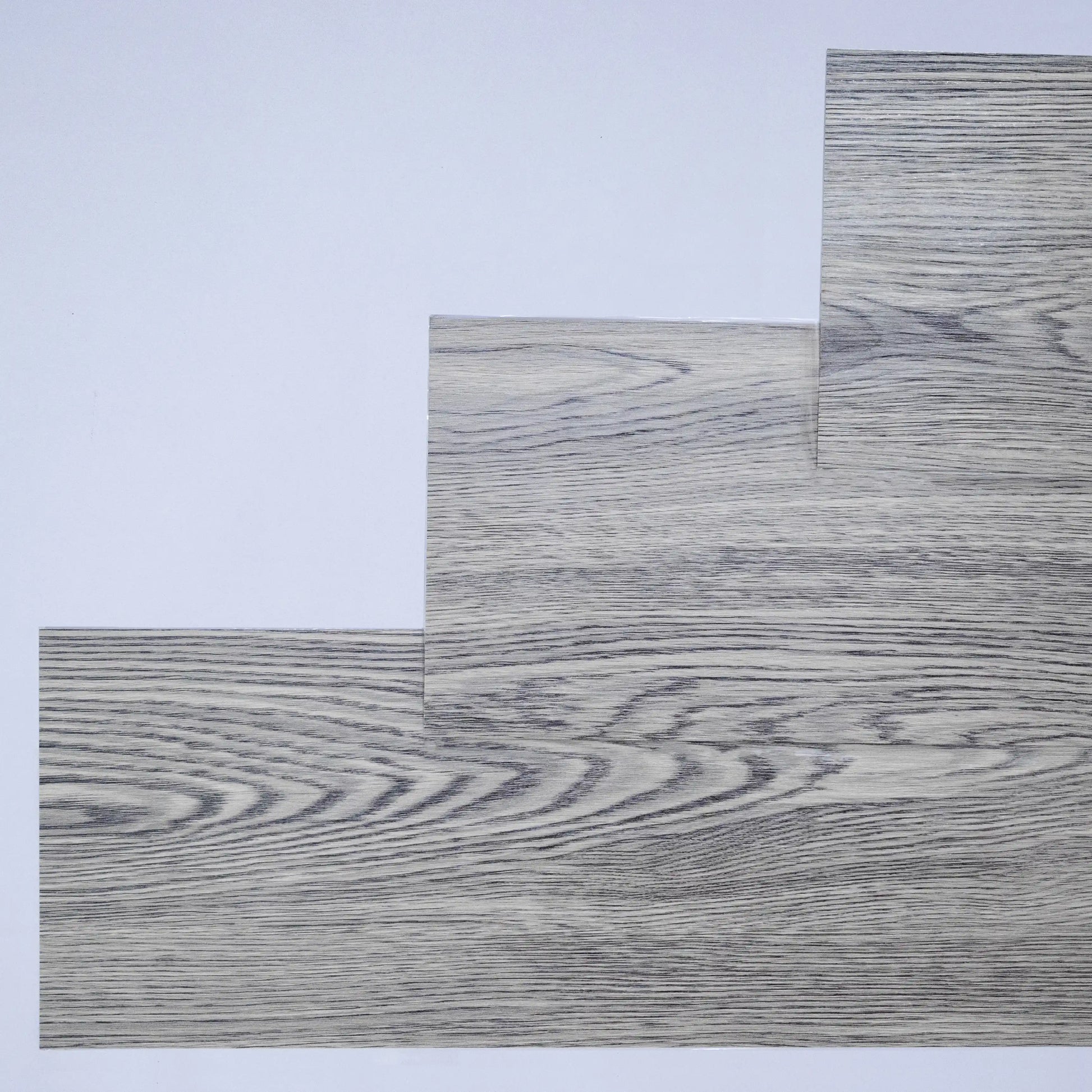 Wooden floor samples with a grayish-brown finish on a white background