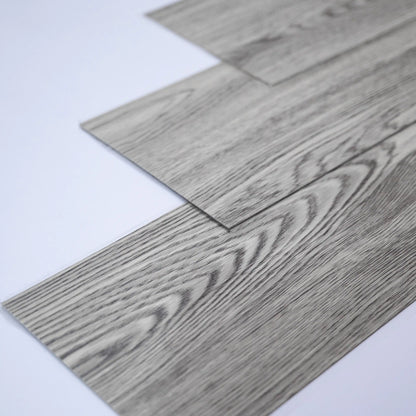 Close-up of gray wood-patterned flooring tiles on a white background