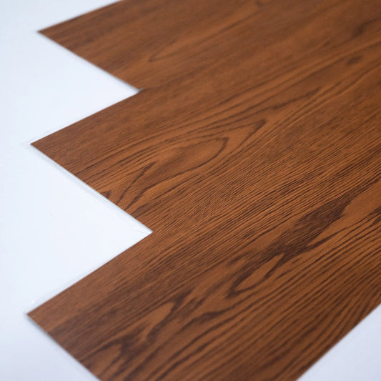Close-up of a wooden flooring sample on a white background