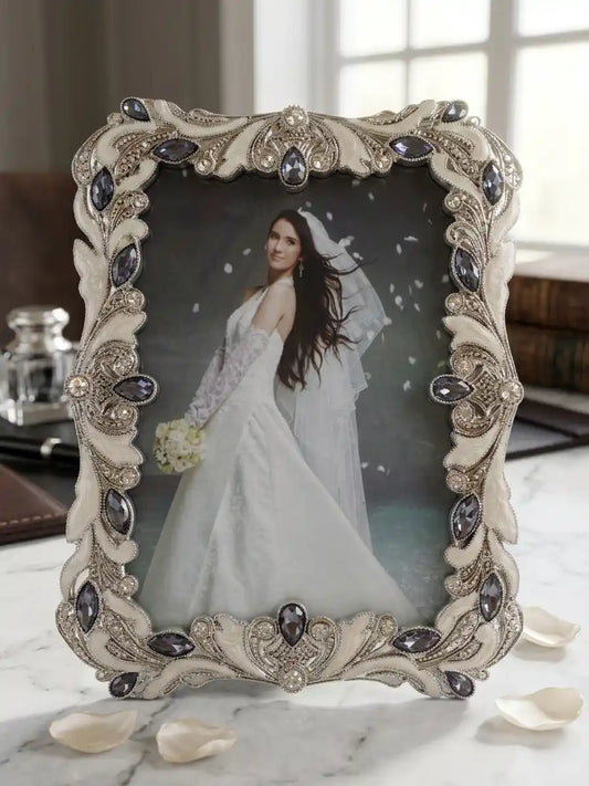 Decorative photo frame with a bride in a wedding dress on a marble surface.