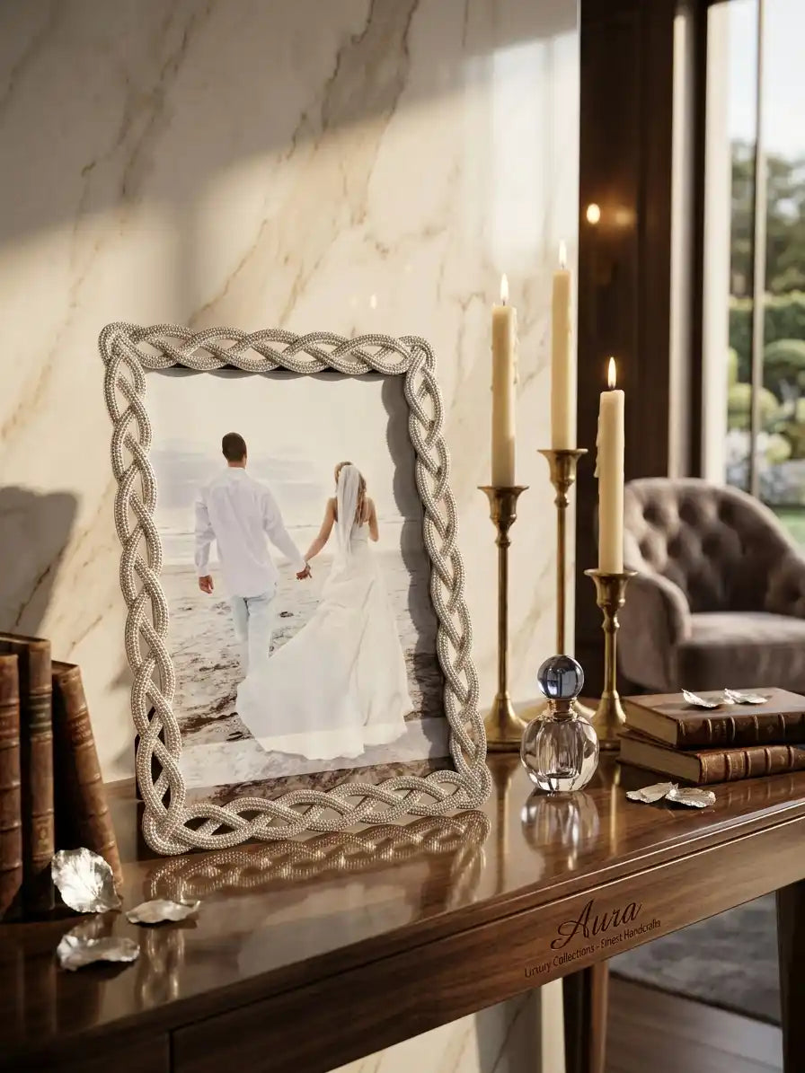 Decorative mirror with a braided frame on a wooden console table, showing a couple holding hands.