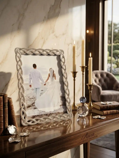 Decorative mirror with a braided frame on a wooden console table, showing a couple holding hands.