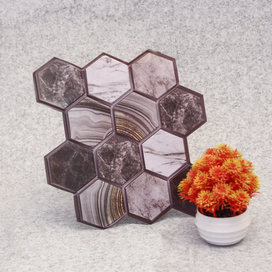Hexagonal marble-patterned tiles on a textured surface with a small potted plant.