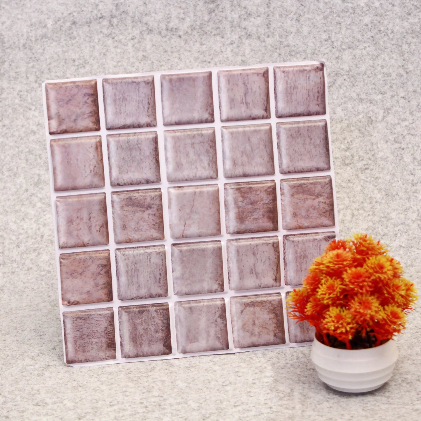 Square tile pattern on a textured surface with a potted plant