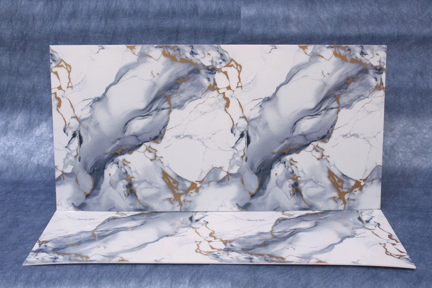 Marble-patterned paper on a blue textured background
