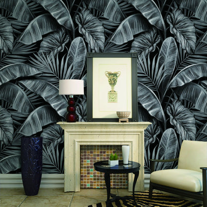 Living room with dark leaf-patterned wallpaper, fireplace, and decorative items.