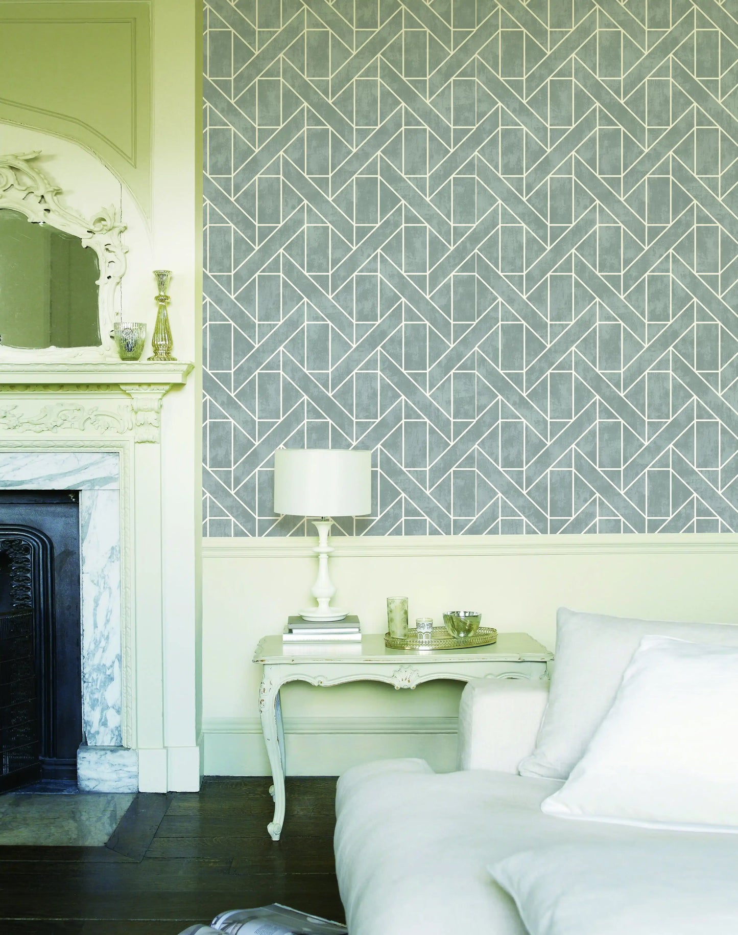 Neatly decorated room with geometric wallpaper, a fireplace, and a side table.