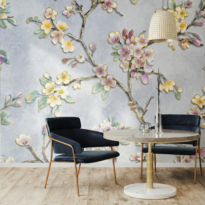 Dining area with black chairs and a round table against a floral wall mural.