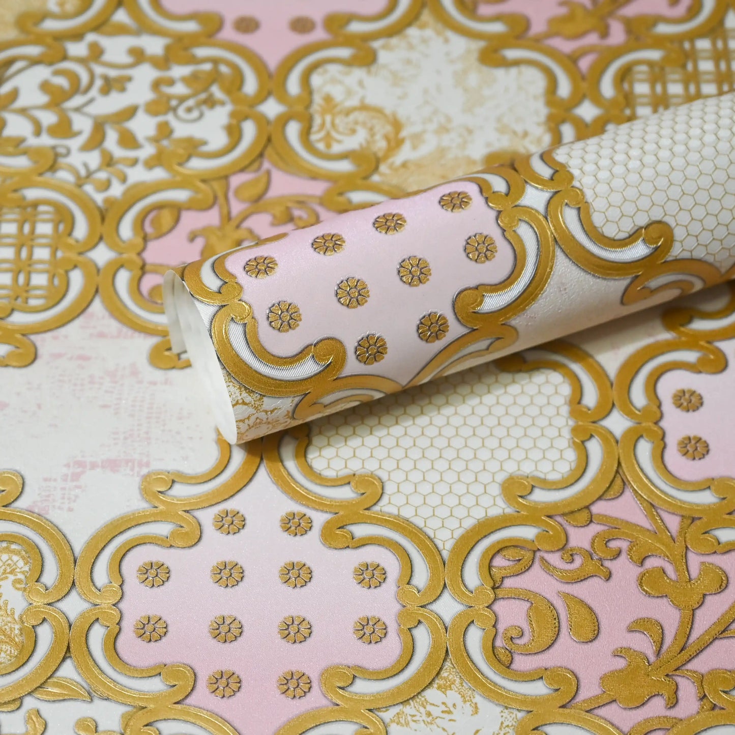 Decorative wallpaper with gold intricate patterns on a pink background