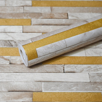 Roll of wallpaper with gold and beige pattern on a matching background