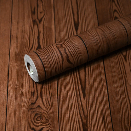 Roll of brown textured wallpaper on a wooden surface